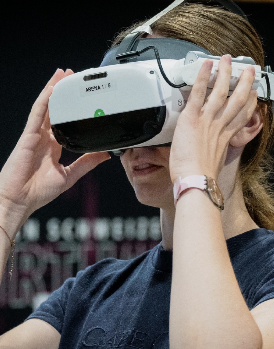 Gast setzt VR-Headset in der Jochen Schweizer Arena München auf